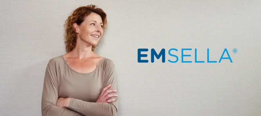 Confident woman with Emsella banner.