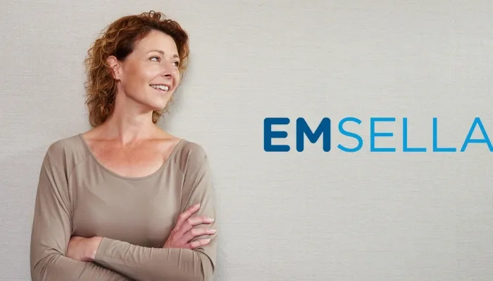 Confident woman with Emsella banner.